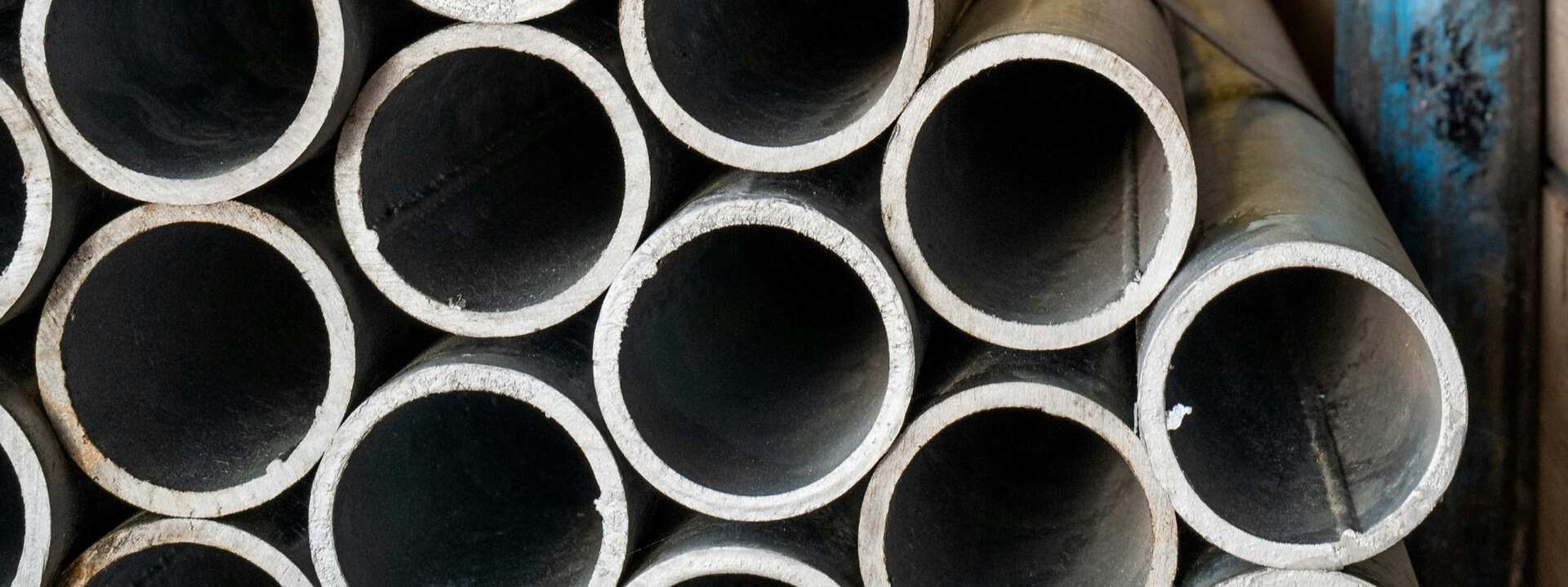 End view of a pile of metal pipes
